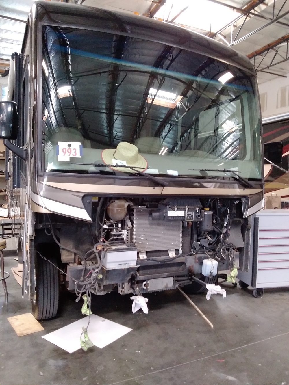 RV front cab and engine bay disassembled for collision repair at Inland Valley RV