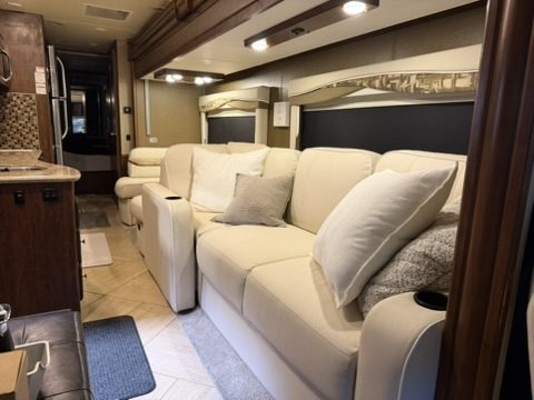 RV living area sofa after reupholstery, clean cream finish