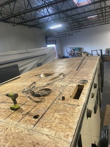 RV roof before repair, exposed decking