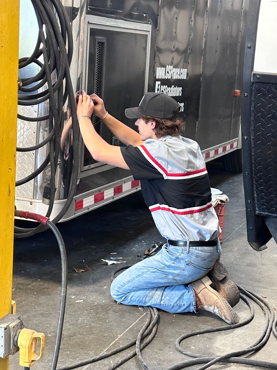 Technician repairing a trailer door and latch